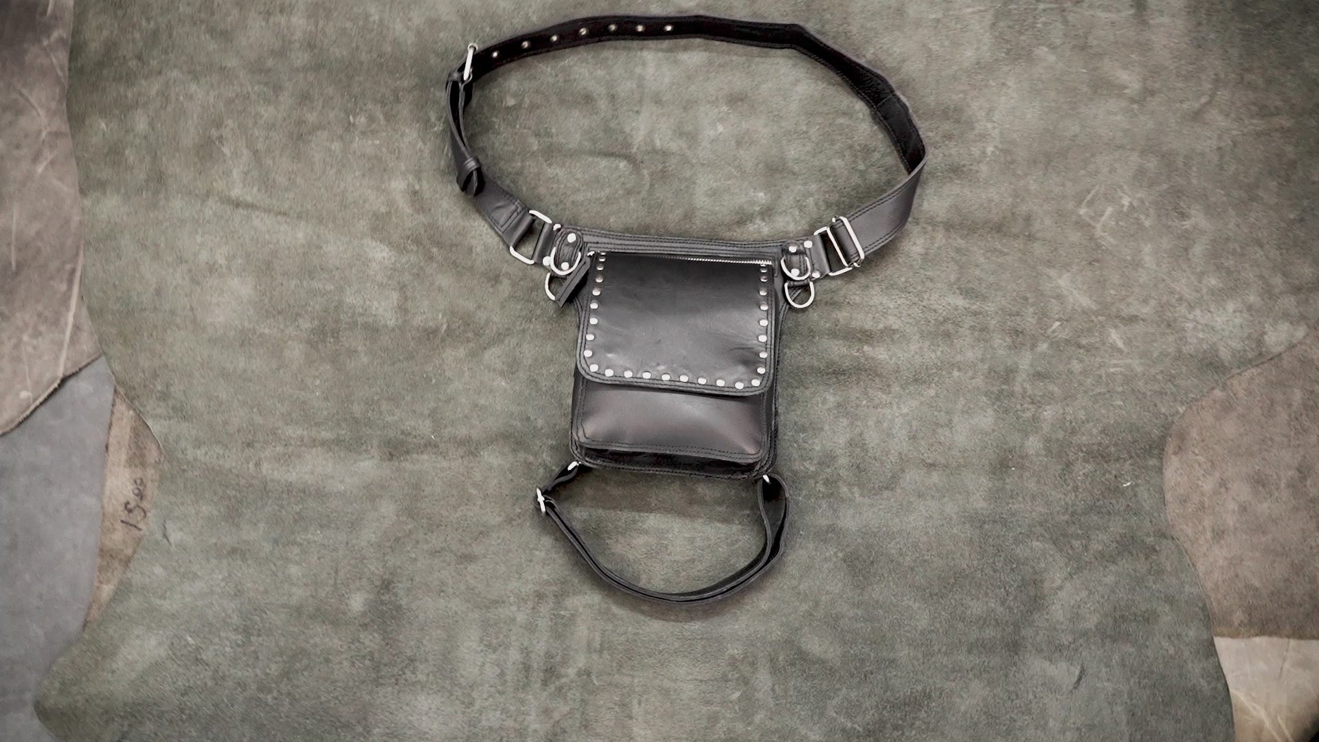 Gothic black leather fanny pack with thigh strap and studded trim.