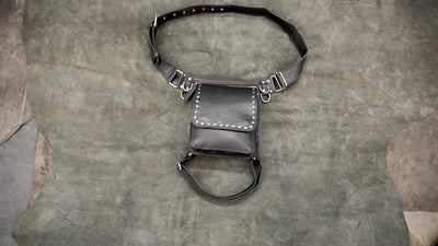 Gothic black leather fanny pack with thigh strap and studded trim.