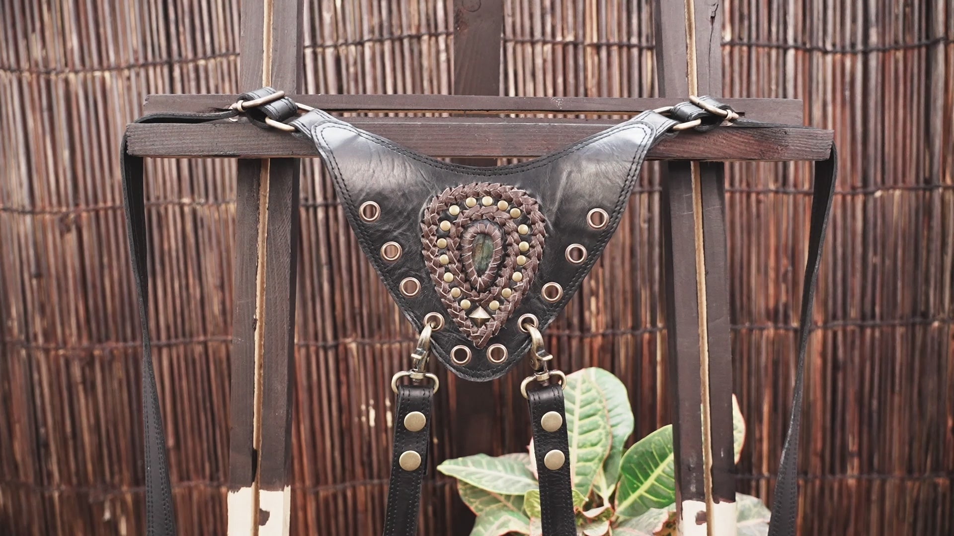 Handmade leather chest holster with decorative studs and adjustable straps