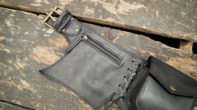 Handmade black genuine leather pocket belt with brass hardware for travel and hands-free storage.