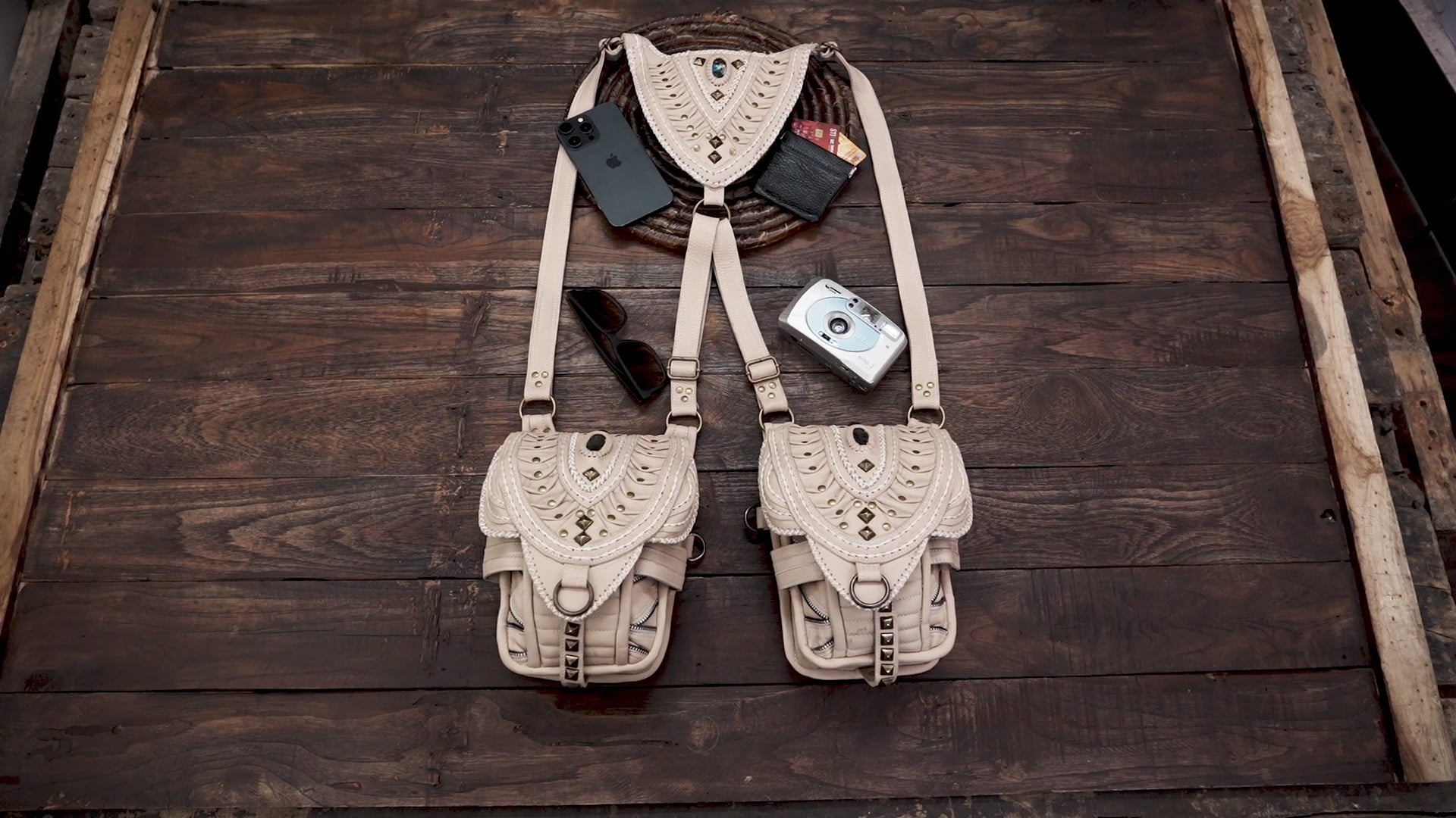 Boho chic cream leather holster bag featuring tribal studs and detailed weaving.