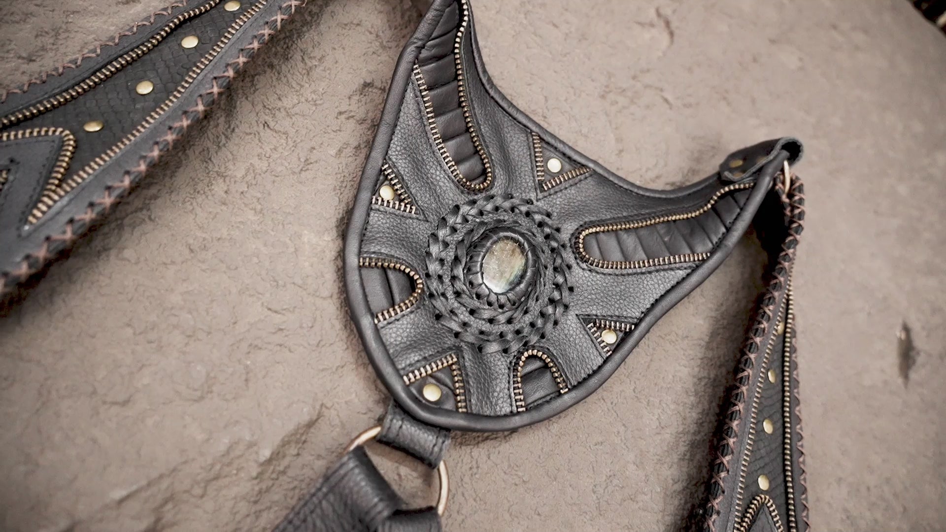 Black leather shoulder bag harness with studded straps and matching pouches