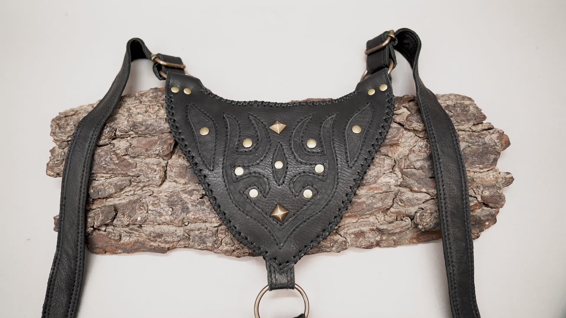 Handmade black leather dual pocket thigh bag with embossed patterns and antique brass-tone studs for Burning Man.