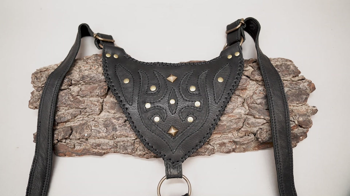 Handmade black leather dual pocket thigh bag with embossed patterns and antique brass-tone studs for Burning Man.