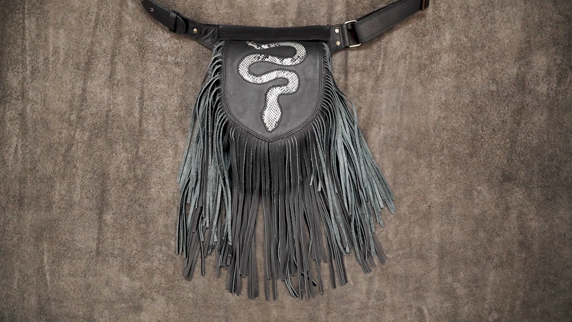 Handmade leather fanny pack with fringe snake design and waist belt