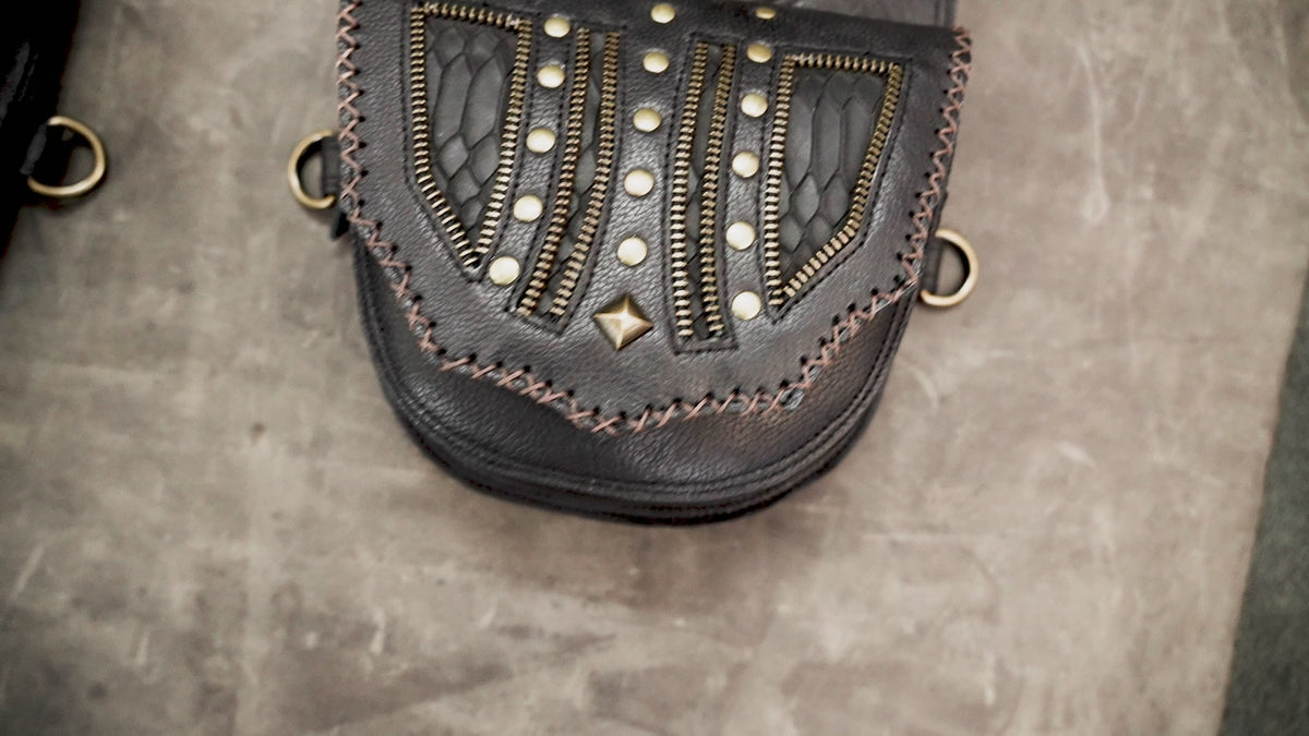 Black leather double thigh bag harness with antique brass hardware

 