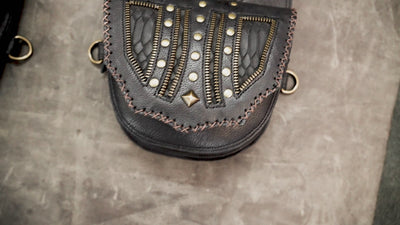 Black leather double thigh bag harness with antique brass hardware

 