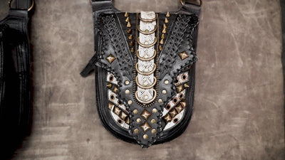 Handcrafted leather dual pouch harness featuring metallic hardware and adjustable shoulder straps