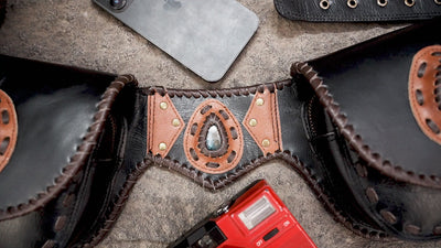 Black leather utility belt with two pockets and decorative stone accents