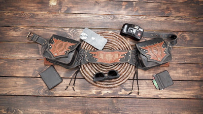 Black leather waist belt bag with western tooling, adjustable belt, and double side pockets