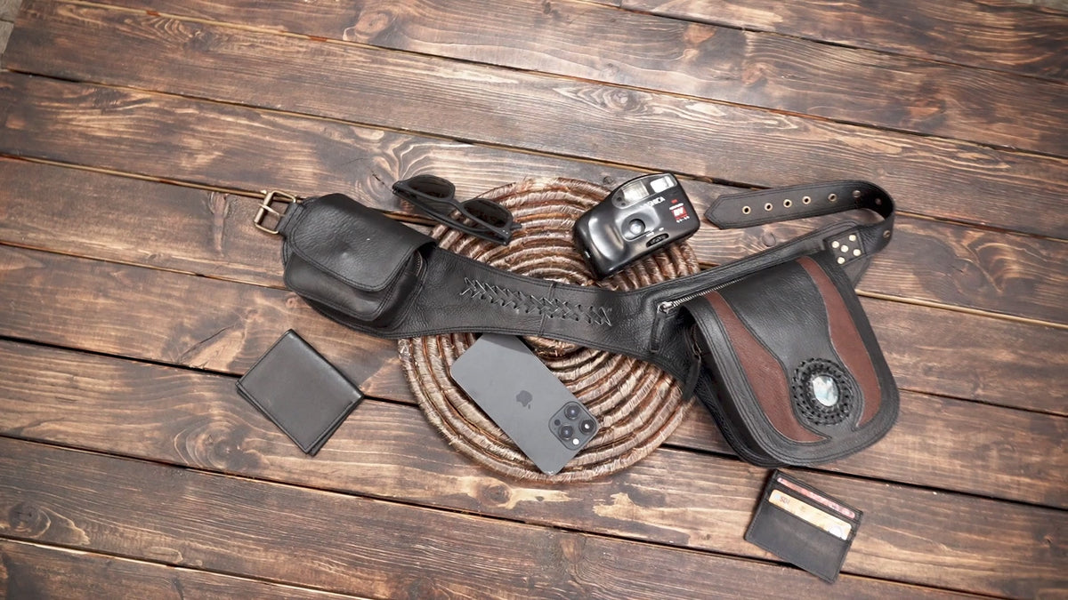 Artisan leather waist pouch belt with dual storage compartments flat lay on wood background