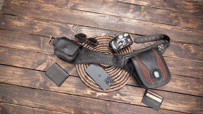 Artisan leather waist pouch belt with dual storage compartments flat lay on wood background