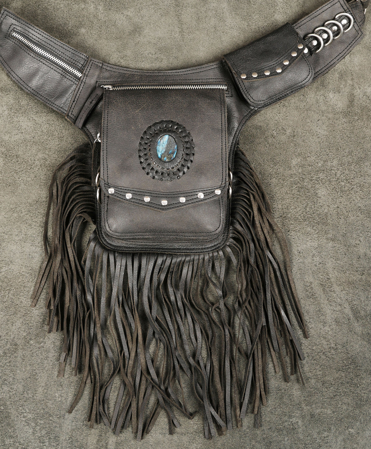 Western leather waist bag with long fringe, flat lay view